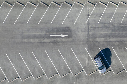 Top view on parking lots with one car