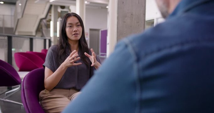 Engaging Meeting Between Business People in Open Plan Modern Office