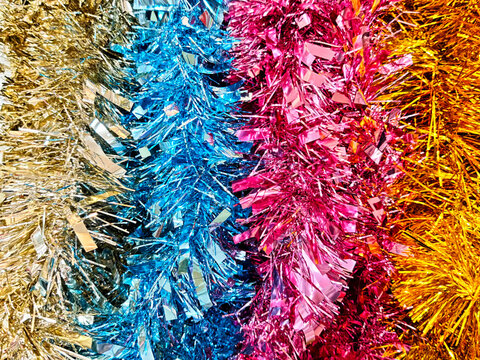 Vibrant and colorful tinsel is showcased in an array of bright hues, perfect for decorative purposes during festive celebrations.