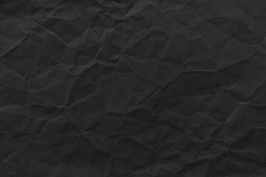 Textured dark crumpled paper background