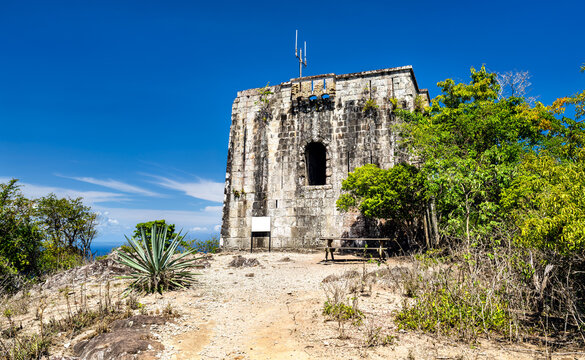 Historic stone watchtower la Tour de la Vigie on top of the hill with surrounding tropical vegetation in Terre-de-Haut, Guadeloupe.