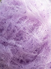 Fototapeta premium Macro Close-up of Fluffy Purple Cotton Candy Texture with Sugary Fibers and Sweet Lavender Candy Floss Background