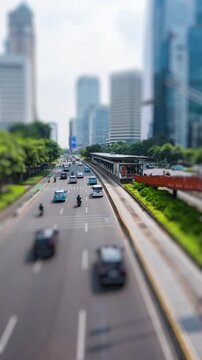 Vertical video - Timelapse of a main busy road in Jakarta in the morning, tilt-shift effect