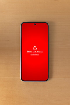 Vertical top view of smartphone displaying security alert