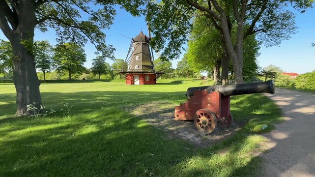 Windmill and historic cannon at Kastellet fortress in Copenhagen, Denmark
