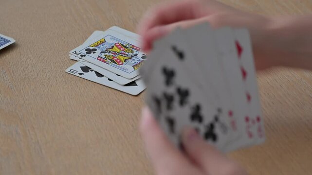Close-up of playing cards on a table during a card game