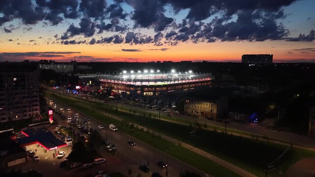 Aerial shot of Widzew Stadium with evening city skyline in Lodz, Poland