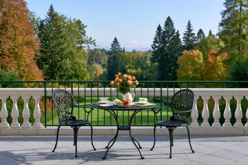 Obraz premium Terrace table setting ready for tea overlooking autumn garden