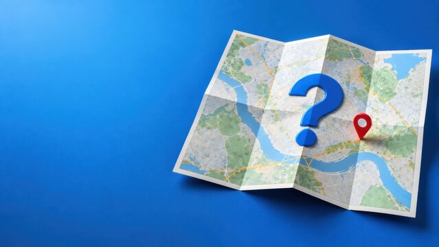 Blue question mark and red location pin placed on folded paper city map over blue background.