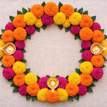 Colorful marigold flower circle with diya lamps for traditional festival decoration