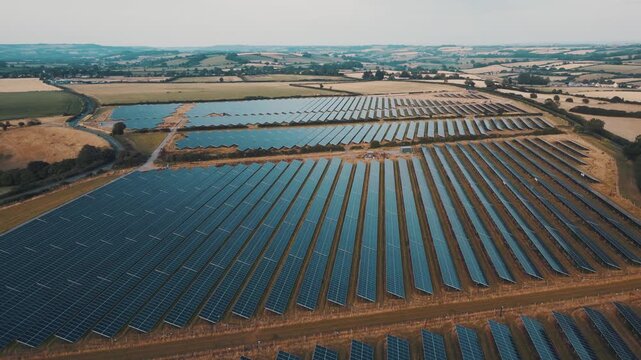 Aerial view of rows of solar panels in fields