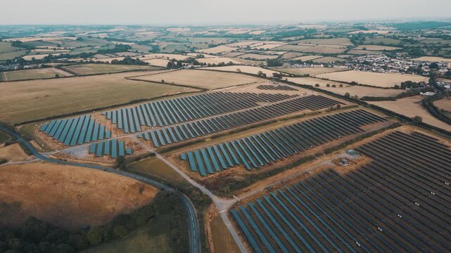 Aerial view of rows of solar panels in fields