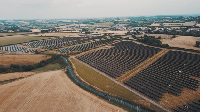 Aerial view of rows of solar panels in fields
