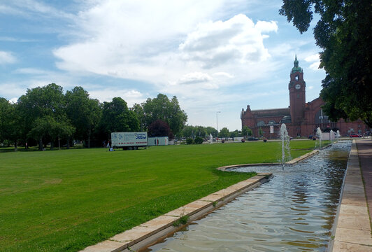 Herbert and Reisinger parks with fountains and Wiesbaden Central Station in Hesse, Germany