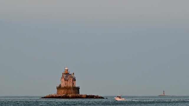 Ship Sailing Through a Coastal Harbor with Lighthouse and Industrial Port Along the River