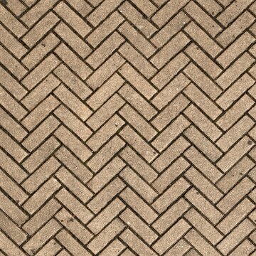 Top view of light brown herringbone pattern brick pavement or wooden parquet floor texture background.