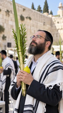 Man raising lulav plus etrog at western wall, tall portrait of sukkot devotion beside fellow worshippers in jerusalem, seasonal retail campaign for sacred festival message
