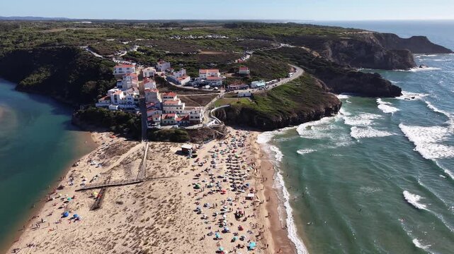 People sunbathing on odeceixe beach in portugal aerial view