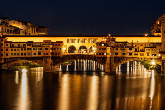 Ponte Vecchio bridge illuminated at night over the Arno River in Florence, Italy