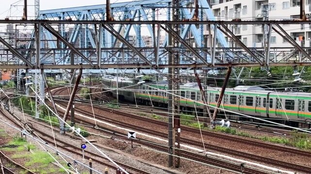 Five-times-speed view of Shonan-Shinjuku Line, Keihin-Tohoku Line and Keikyu trains weaving through a dense urban rail corridor