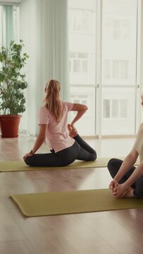 Women stretching together in a yoga class