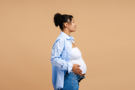 African american pregnant woman profile view embracing motherhood