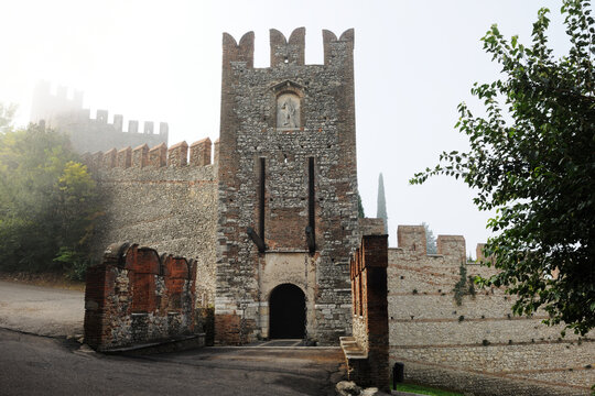 Mystical castle in foggy morning