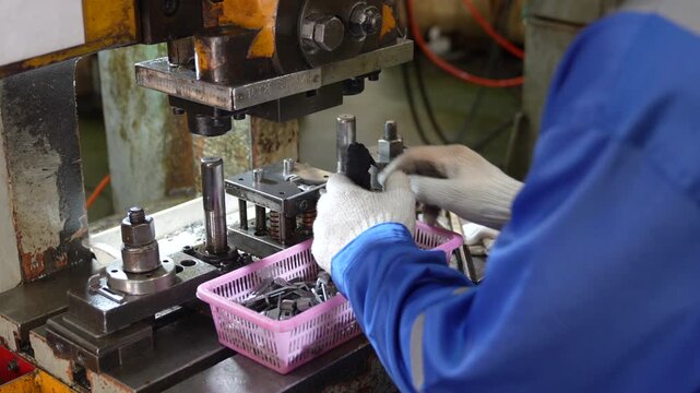 Industrial Worker Operating Metal Stamping Press Machine With Protective Gloves, Metal Parts, Factory Workshop Manufacturing Machinery Production Area
