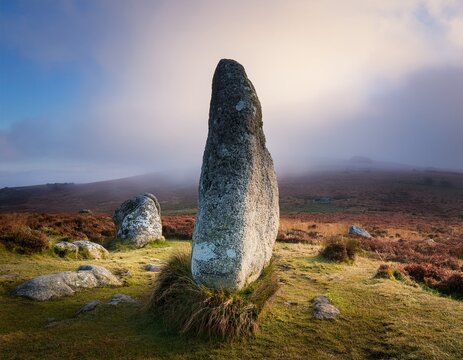 ancient standing stone monolith on a misty moorland dartmoor national park uk evoking mystery and history