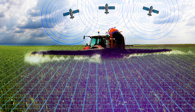  Red Tractor spraying pesticides over a green field in spring