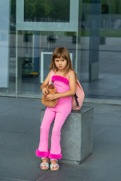 Little girl going on holiday with suitcases at airport