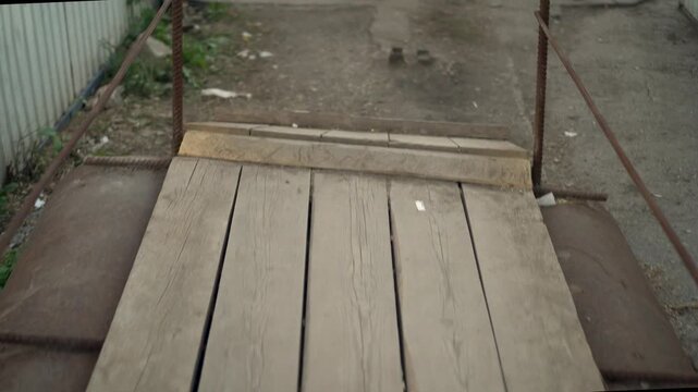 Temporary Wooden Construction Bridge with Metal Elements, First-Person Camera Moving Along the Bridge