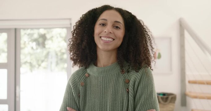 Camera pulling back, African American woman opening arms, tucking sweater in jeans by sliding door