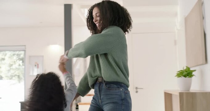 African American mother and daughter running, child grabbing hands to play, spinning in entry