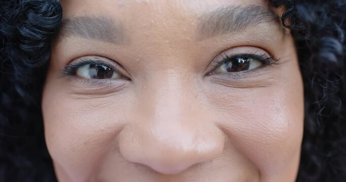 Maintaining steady gaze, blinking, woman is leaning in close-up forming warm smile with ring glints