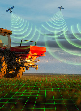 Tractor spreading artificial fertilizers in field