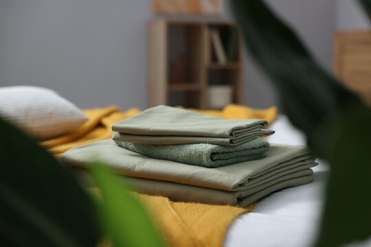 Home textile. Fresh clean linens and towel on bed indoors, closeup