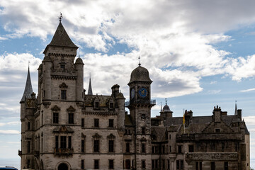 Castle with clock tower and spires under cloudy sky at Dunrobin Castle, Scotland, UK. © iSky Media
