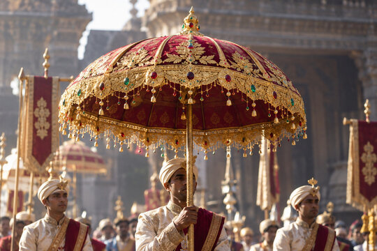 Ceremonial portable umbrella adorned with gold leaf and gemstones.