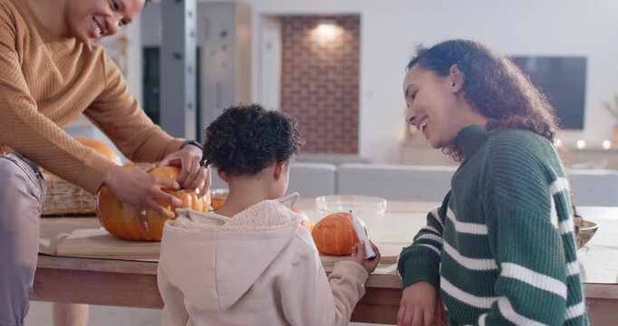 African American family at home as man placing pumpkin, carving and child drawing with black marker