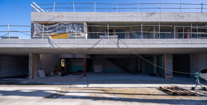 Stone architecture under construction with concrete facade