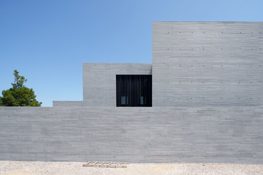 Minimalist concrete hotel facade under clear blue sky