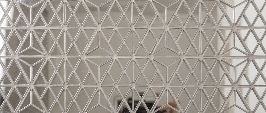 Diamond shape pattern mirror mosaic. Geometric decorative glass wall