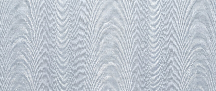 Moire wallpaper watered silk effect. Light blue wavy pattern background