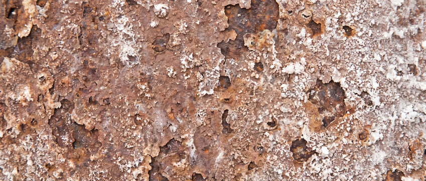 Salt corroded metal texture with white salt crust and orange rust flakes. Chemical degradation background