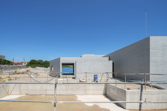 Modern hotel building under construction against blue sky