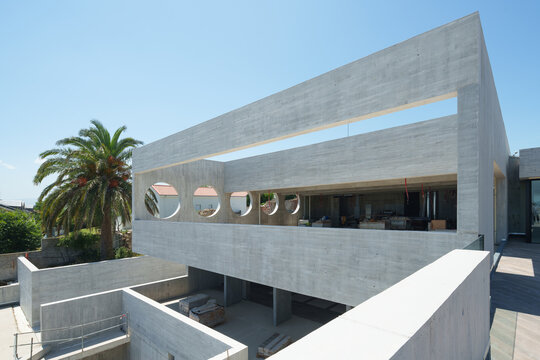 Modern concrete hotel building with geometric open facade