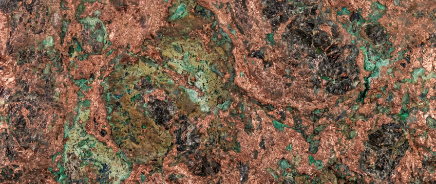 Raw copper ore mineral texture. Close-up of geological rock specimen with green malachite and bronze metallic veins. Natural mining material abstract backdrop