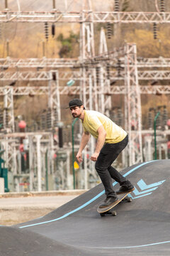 Man skateboarding on pump track in urban outdoor park