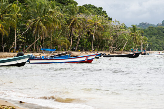 Colorful fishing boat moored off a tropical Costa rica beach